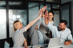 Group of coworkers high five each other